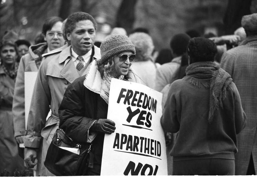 Rosa Parks joins a march outside the South African Embassy in Washington, DC, protesting that country's apartheid policies.