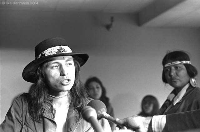 The late John Trudell’s ‘We Have the Power’ is one of the most hard-hitting of the collection. Image Credit: Ilka Hartmann  http://frontierpartisans.com/wp-content/uploads/2015/12/John_Trudell_speaking.jpg 