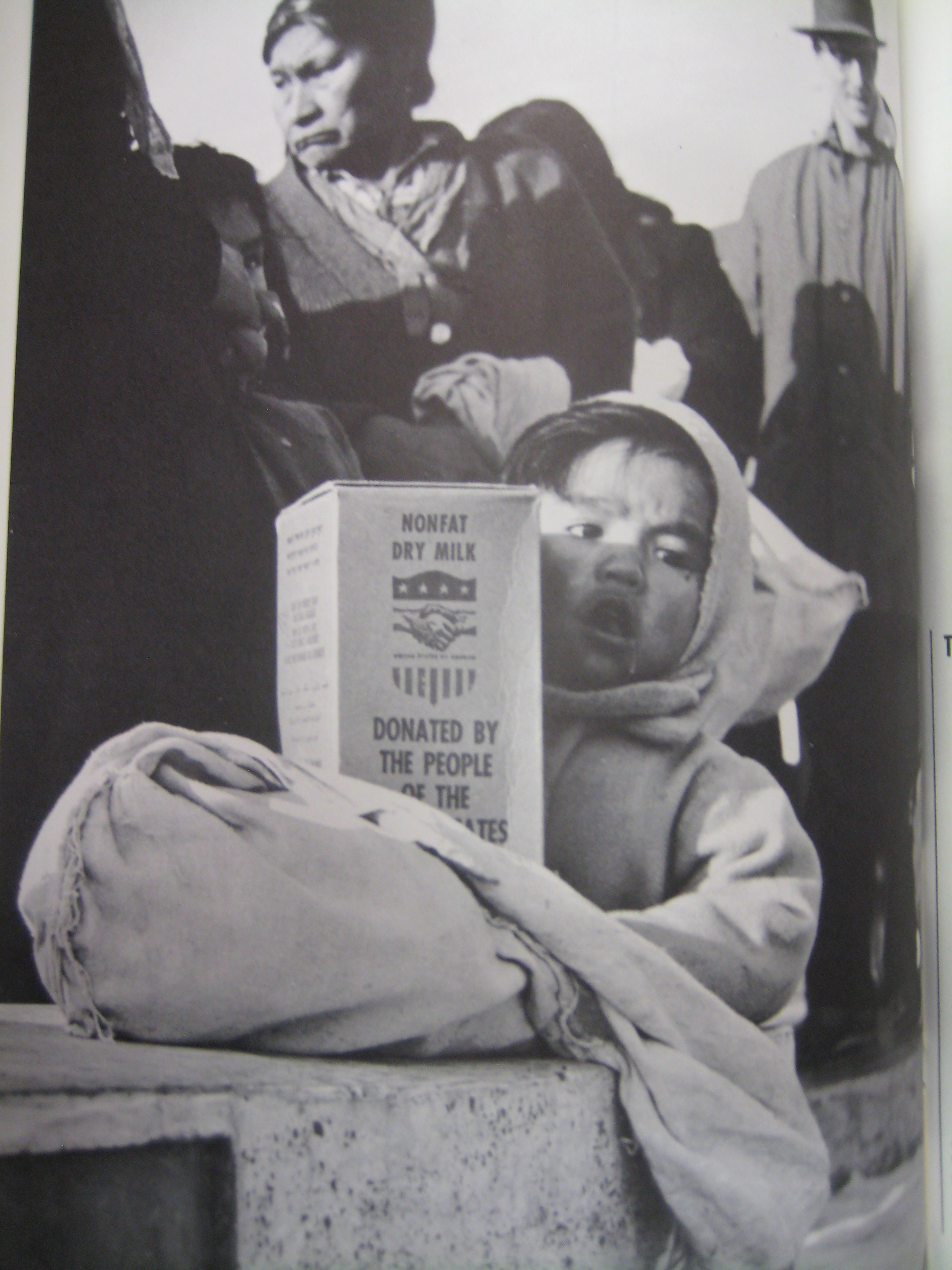 A child holds a box of food distributed under Food for Peace, bearing the label “Donated By the People of the United States of America”. Source: “Food for Peace: 1964 Annual Report on Public Law 480,” March 1965, Lyndon Baines Johnson Presidential Library, Office Files of the White House Aides, Files of Bill Moyers, Box 116.