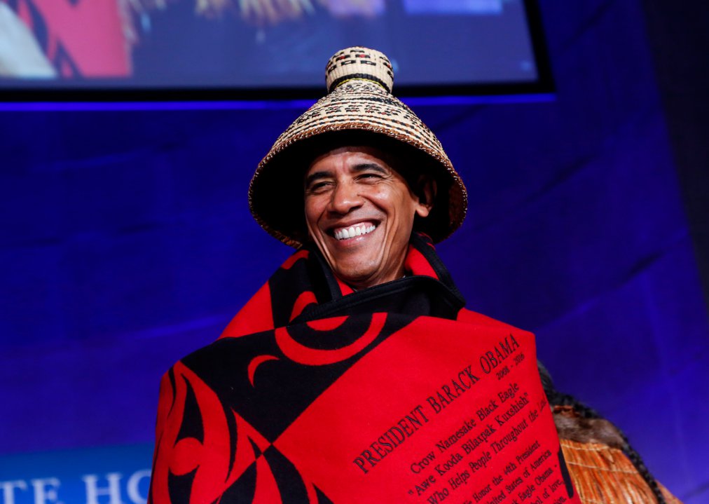 WASHINGTON, DC - SEPTEMBER 26: US President Barack Obama receives a traditional blanket and hat during the 2016 White House Tribal Nations Conference at the Andrew W. Mellon Auditorium, September 26, 2016, Washington, DC. The conference provides tribal leaders with opportunity to interact directly with federal government officials and members of the White House Council on Native American Affairs. (Photo by Aude Guerrucci-Pool/Getty Images)